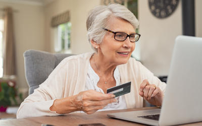 Old Woman Paying Bills Online J745CDU