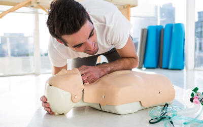 Paramedic Practicing Resuscitation On Dummy PY9XG2E