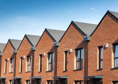 RBH homes in Lower Falinge with a blue sky