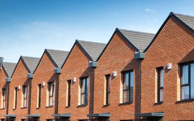 RBH homes in Lower Falinge with a blue sky